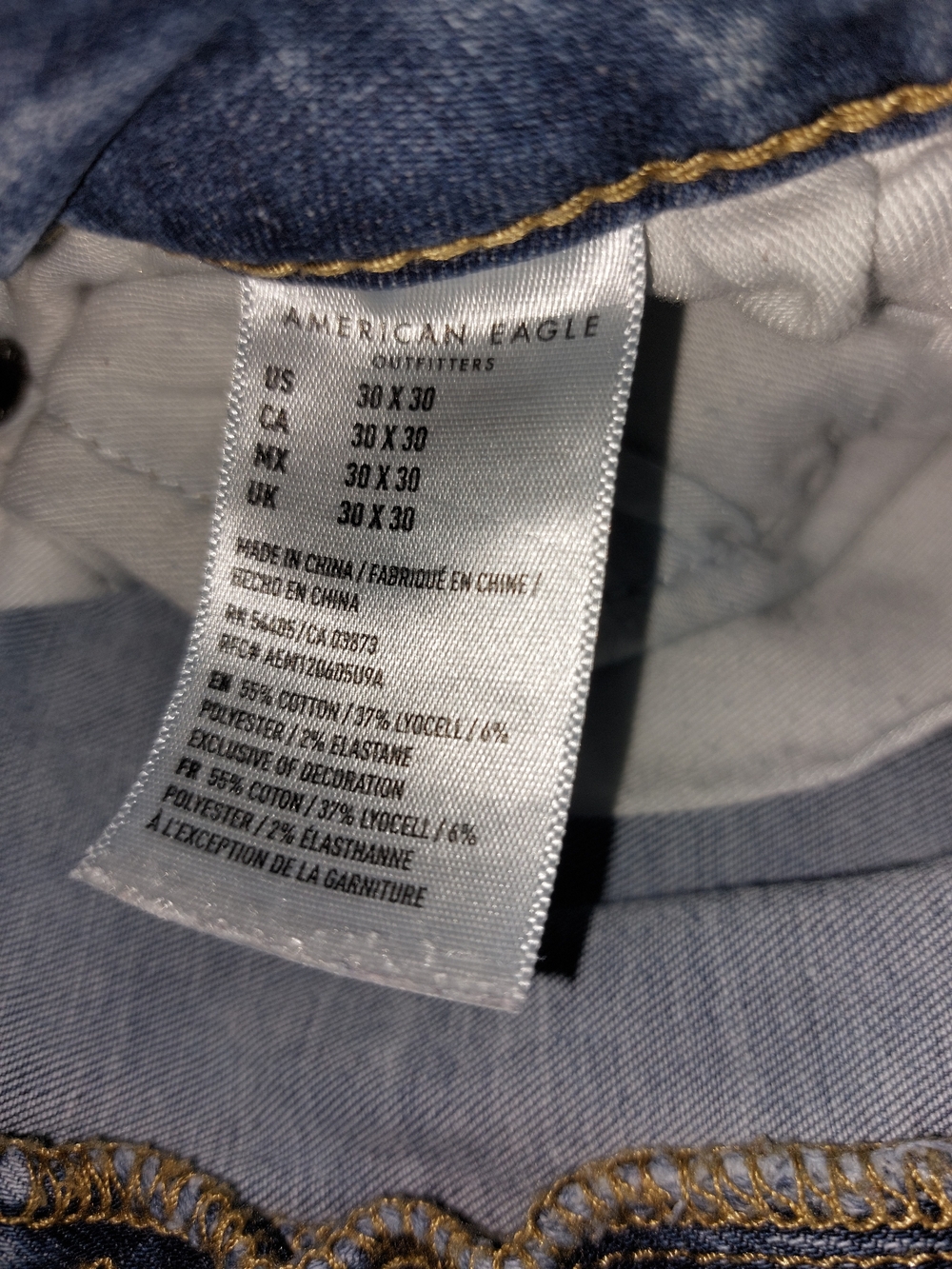 American Age light blue denim jeans with tan patch